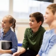 Group Of Happy Kids Or Friends Learning At School P5pue9y